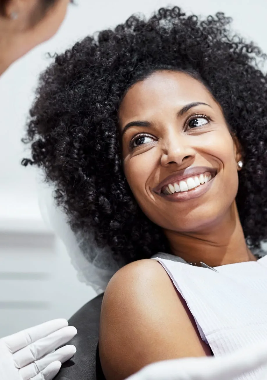 woman with curly hair smiling